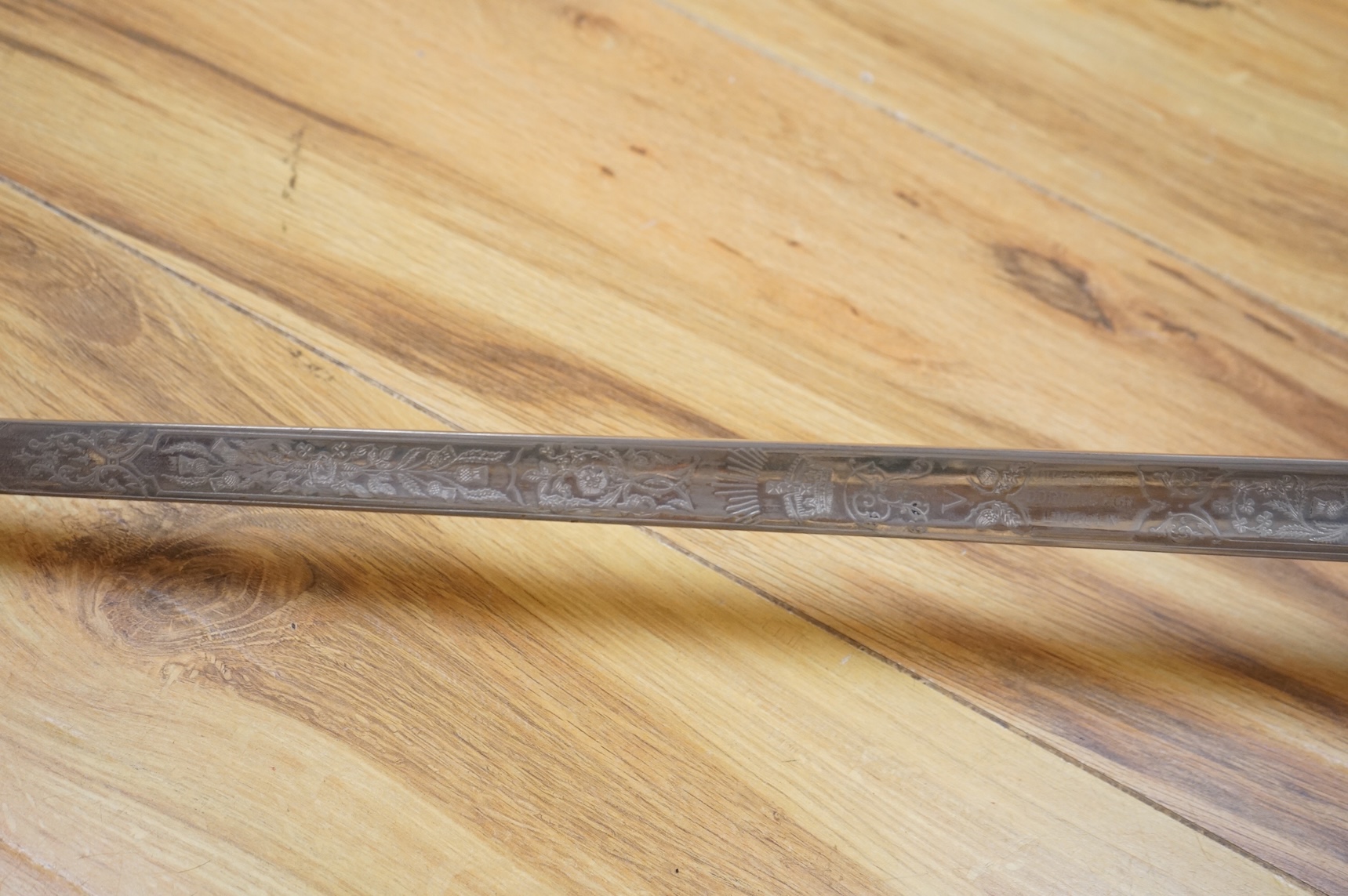 A George V 1897 pattern infantry officer’s sword, with regulation blade etched with the union flowers, Royal Arms and owners name; J.W. Reynolds, Dorrington, Lincoln, regulation nickel guard stamped ‘WH&S’ in minuscules,